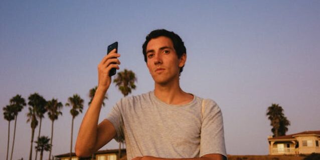 pexels-athena-2962238 man holding phone
