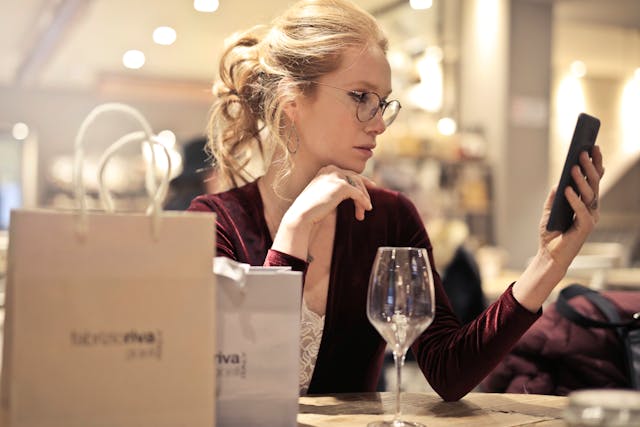 woman at restaurant looking at phone