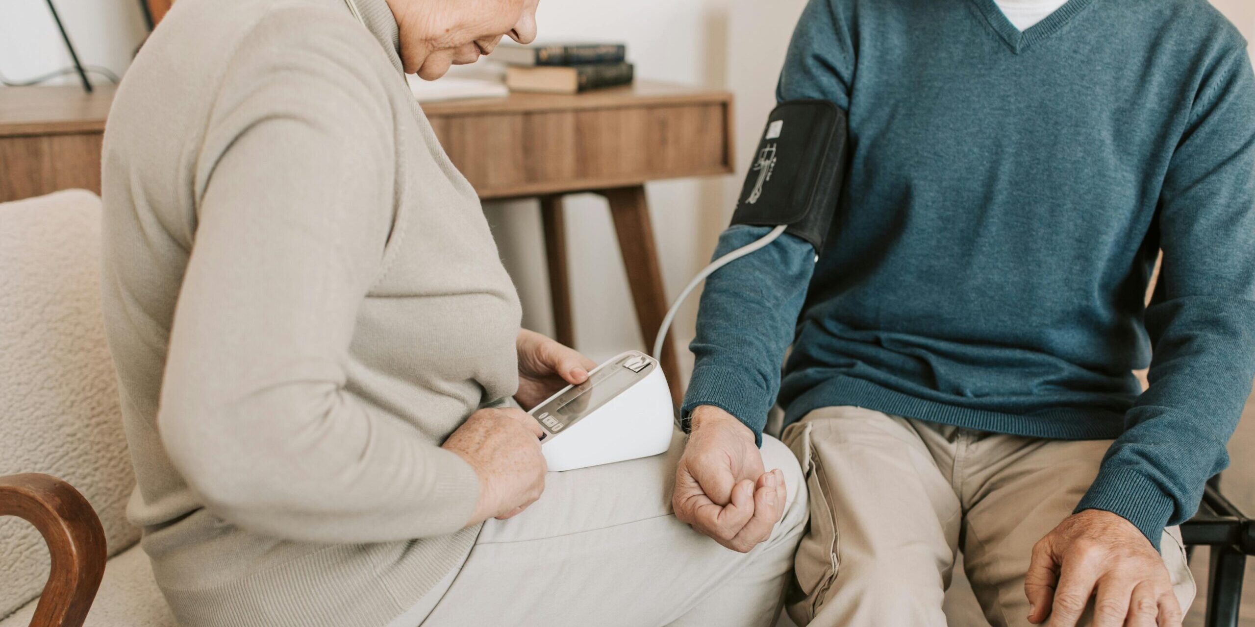 PD page couple wife checking bp for husband at home